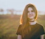 Woman Wearing Black Crew-neck T-shirt and Black Choker Necklace